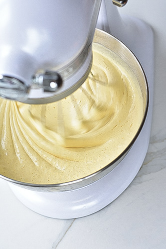 eggs and sugar are being whisked in a stand mixer