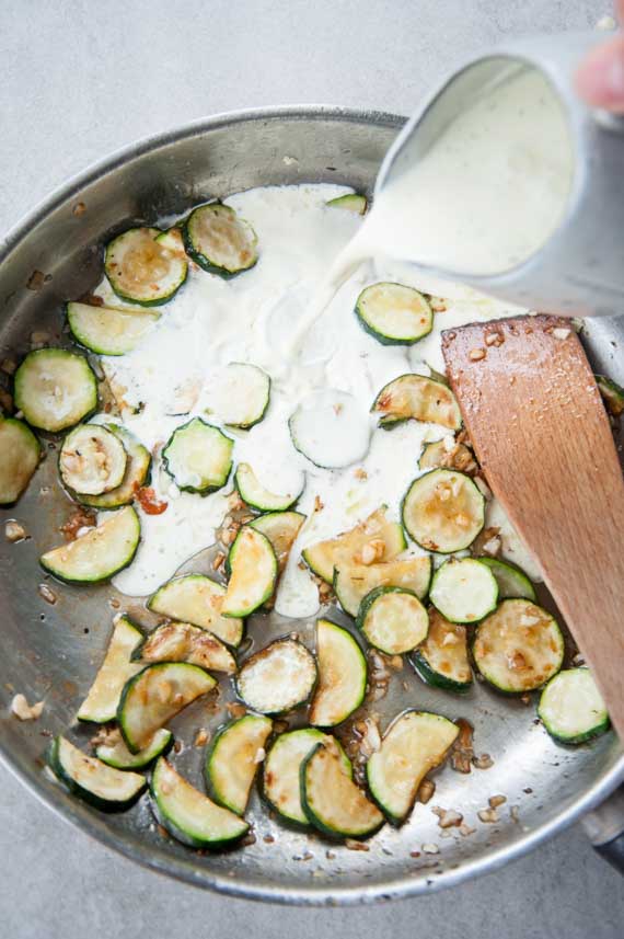 cream is being poured into a pan