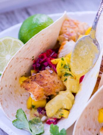 Fish tacos with mango salsa on a plate.