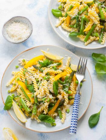 Pasta primavera on a blue plate.