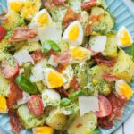 Pesto potato salad on a blue plate.