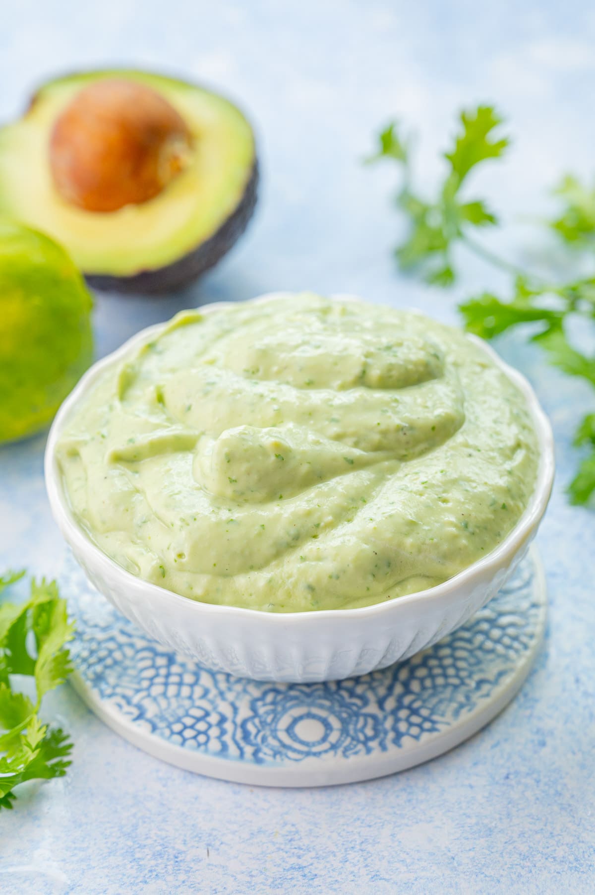 Avocado sauce in a white bowl.