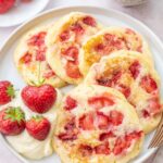 Strawberry pancakes on a white plate.