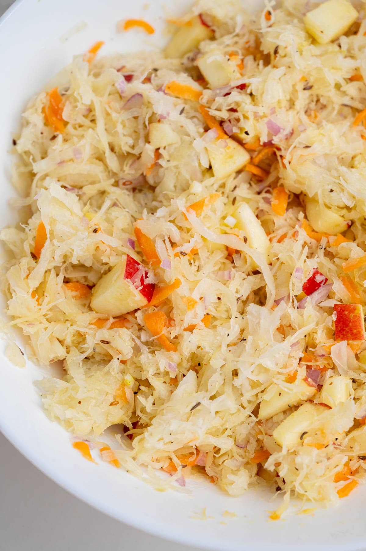Sauerkraut salad in a white bowl.