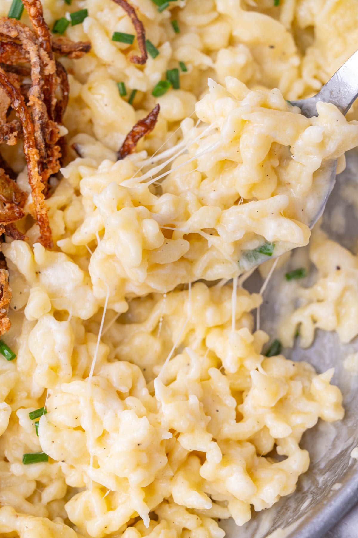 A close-up photo of Käsespätzle in a frying pan.