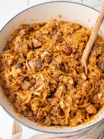 Bigos stew in a big white pot.