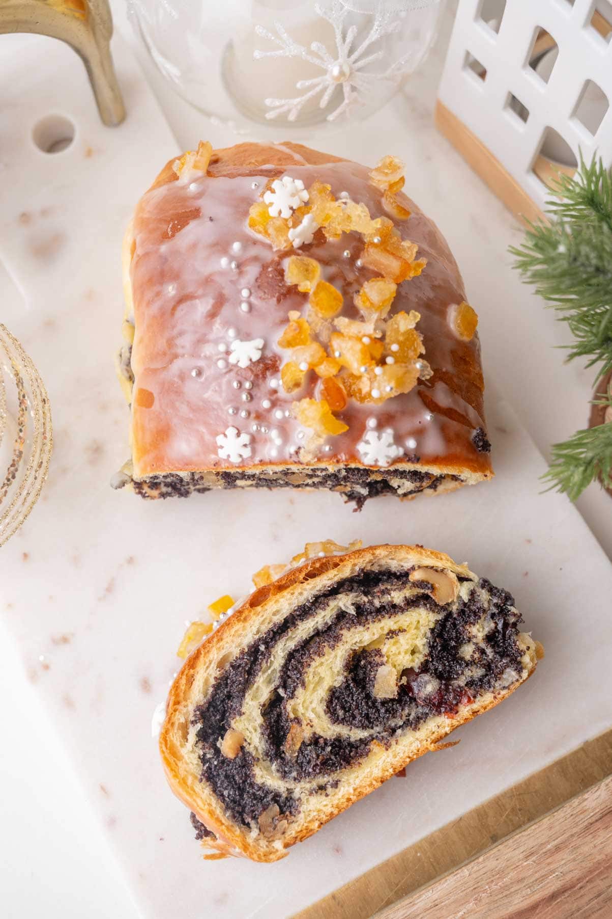 Poppy seed roll on a marble board - overhead picture, with one slice on the side.